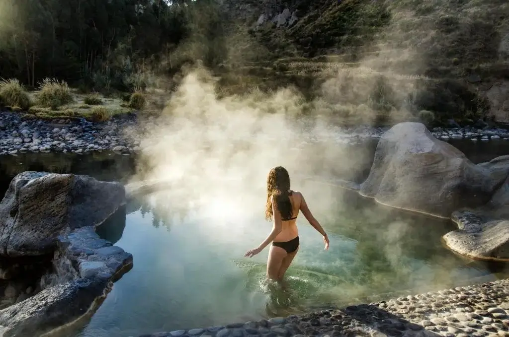 Relaxing natural hot springs in Colca Valley surrounded by lush greenery and mountains | Andean Travel Experience Relaxing natural hot springs in Colca Valley surrounded by lush greenery and mountains | Andean Travel Experience