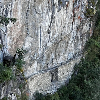 Inca Bridge at Machu Picchu | Andean Travel Experience Inca Bridge at Machu Picchu, Peru – Ancient stone pathway built along a steep mountainside | Andean Travel Experience