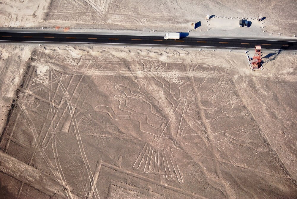 Aerial view of the Nazca Lines in Peru showing intricate geoglyphs in the desert | Andean Travel Experience Aerial view of the Nazca Lines in Peru showing intricate geoglyphs in the desert | Andean Travel Experience