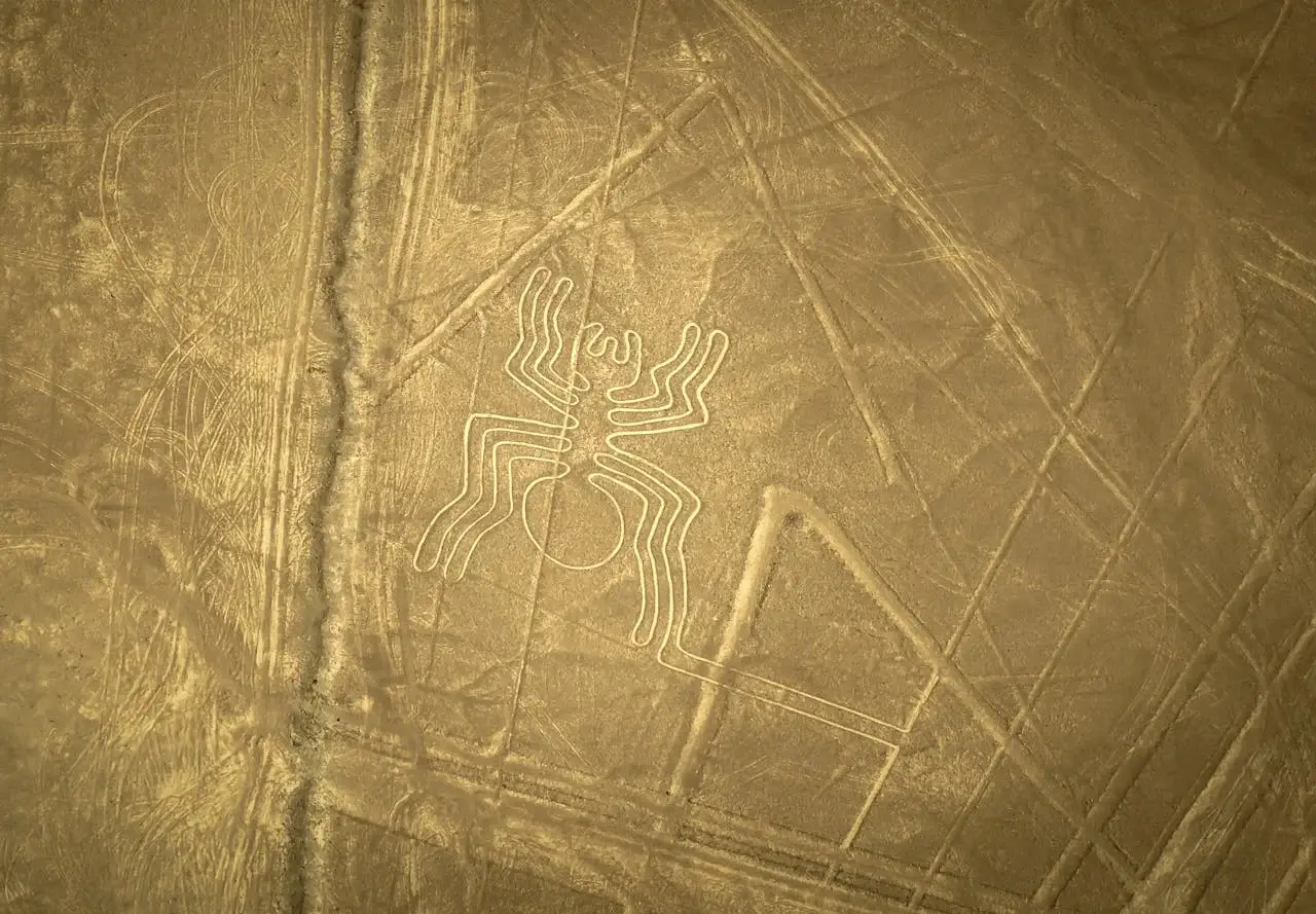 Nazca spider geoglyph with desert landscape in the background | Andean Travel Experience Nazca spider geoglyph with desert landscape in the background | Andean Travel Experience