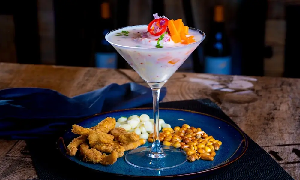 Traditional Peruvian ceviche served with fresh fish, lime juice, red onion, chili, and corn | Andean Travel Experience Traditional Peruvian ceviche served with fresh fish, lime juice, red onion, chili, and corn | Andean Travel Experience