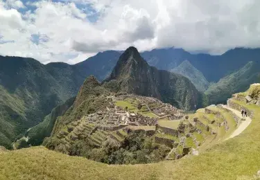 Panoramic view of the ancient Inca ruins of Machu Picchu, nestled in the Peruvian Andes | Andean Travel Experience Panoramic view of the ancient Inca ruins of Machu Picchu, nestled in the Peruvian Andes | Andean Travel Experience